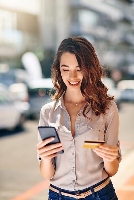 Lady using a card with her smartphone