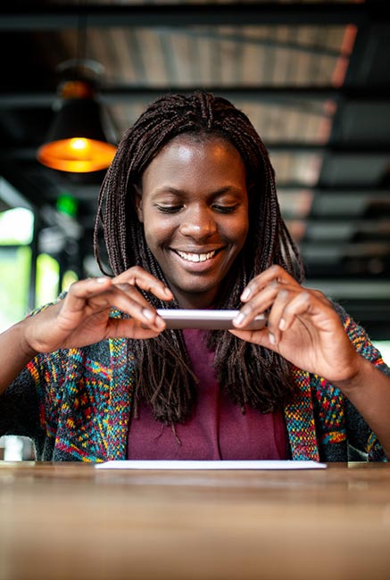 Lady making a mobile deposit in a restaurant